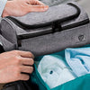 Grey colored, hanging, waterproof toiletry bag with external and internal pockets.